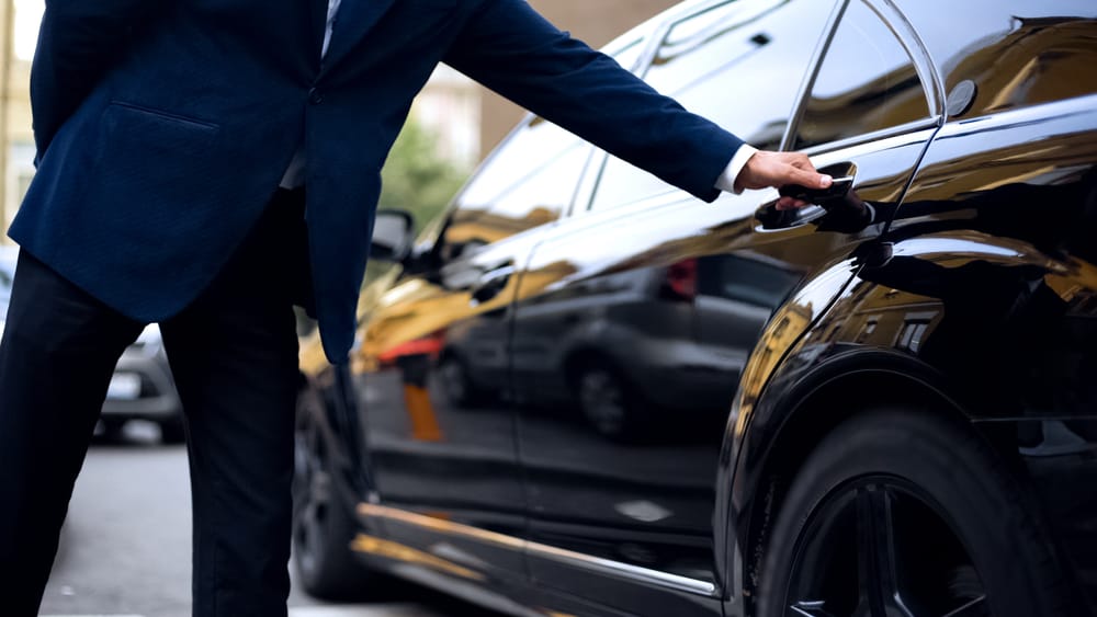 A man opening a door for a client